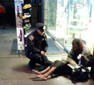 NYPD policeman Larry DePrimo gives boots to a homeless man