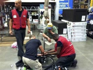 Lowe's employees David, Marcus, and Souleyman fix Michael Sulsona's wheelchair